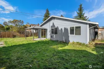 Concrete patio with sturdy metal gazebo—perfect for barbecues, entertaining, or relaxing in the shade.