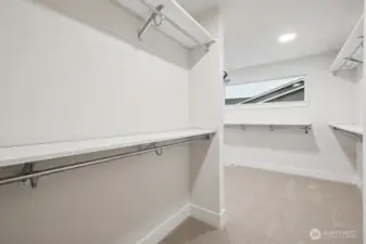 Primary walk-in closet offers plenty of space and organization.