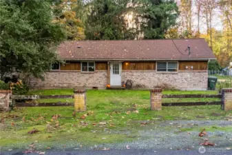Unit 2 Entrance - Full front elevation showcasing the single-story layout, brick and wood siding details, and dual entry setup ideal for duplex functionality.