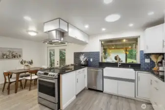 Dream kitchen with full height tile backspash, granite counters, stainless appliances and a Fabulous huge Farm sink!  French doors lead to the massive covered back deck.