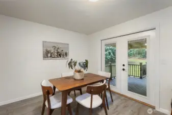 Dining room with french doors to covered deck in backyard
