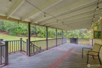 BIG covered back deck is made of Synthetic wood for ease of maintenance and longevity.  What a wonderful place to sit and enjoy the sounds and sights of nature...in ANY weather!