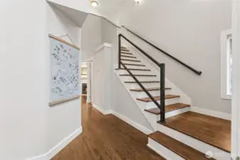 As you enter the home, you will find this dramatic 2-story entry with legit hardwood floors and staircase with modern touches.