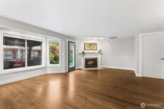 View of your family room from the kitchen. Large, open space and wall of windows! Plus your back door to your large covered deck. Gas fireplace for our cooler evenings. Door to your right leads to your utility room and garage.