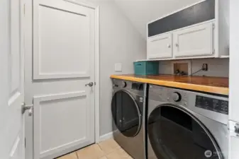 Utility room view, door leads to your garage, love the storage and folding shelf!