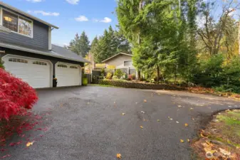As you pull up the driveway to the home, you will note the expanded parking/turnaround asphalt area for you and your guests.