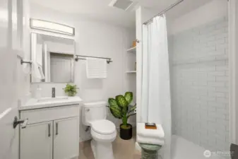 The spacious main floor bathroom offers a shower for overflow or guests.