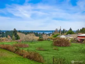 The 6 acre parcel provides an open meadow with views of the Cascades and Sound in the distance.