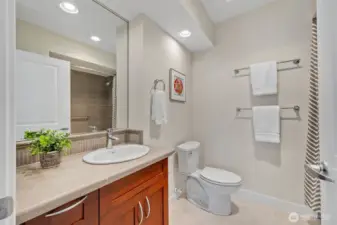 Spa-inspired full bathroom near the second bedroom.