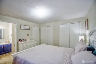 Primary suite with double closets and a private half bath