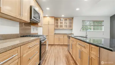 The kitchen is the heart of the home with a spacious island, recessed lighting, and stainless steel appliances.