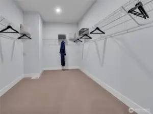 Extra large primary walk-in closet is ready to be filled.  Photo is of model home-Victorian plan-elements of the Chateau plan can vary