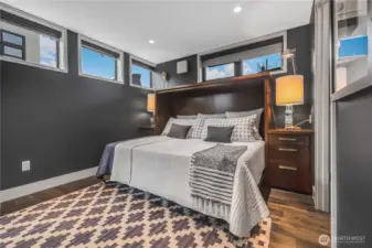 En suite main level bedroom has walk in closet and murphy bed for great guest room or convertible space.