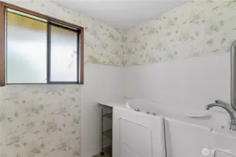Primary bath with walk in tub.