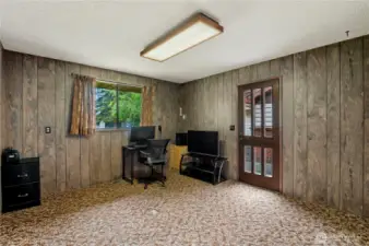 Large den w/ door to the exterior of house.