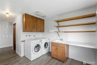 Large laundry room with exterior door to deck.
