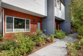 Welcoming entry path framed by beautiful plantings