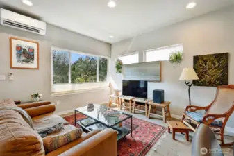 Corner windows flood the rooms with natural light.  Air conditioning units keep the home comfortable at all times.