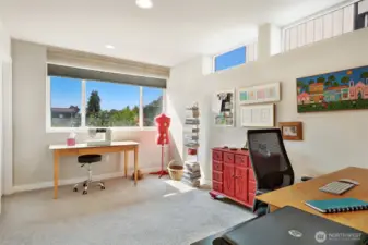 Second guest bedroom on the second floor. This one is south-facing and is currently used as an office and hobby area.  There is a generous walk-in closet with room for clothing and luggage.