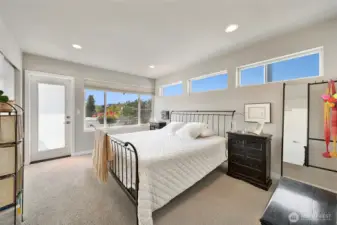 The large primary suite has space for a king-size bed, additional furniture, and lots of light.