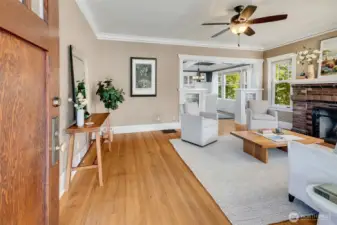 Golden oak hardwood floors throughout the main level, original leaded-glass built-in bookshelves, and a classic brick fireplace that was converted to gas for ease and convenience.