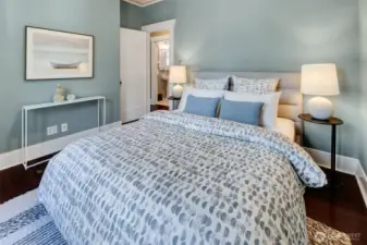 Main floor bedroom with an adjacent full tiled bath.
