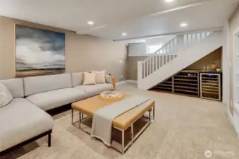Lower level media/family room with built-in wine storage and wine refrigerator * Pro tip- the stair railing was designed to be removable for ease in moving larger furniture or appliances in/out.