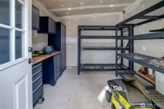 Enviable storage flex workshop space. Yes, the racks and the built-in cabinets stay! This could even be a detached WFH office, art studio, craft space, wood shop, or ????