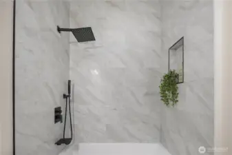 Elegant Tile surround and rain head shower with sprayer.