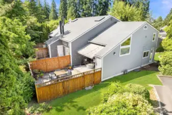 Sun filled lot view of townhouse with yard.  New roof place on unit in Fall of 2025.