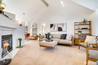 The vaulted ceilings, custom windows,  and gas fireplace add space, light, and warmth to the main living area.