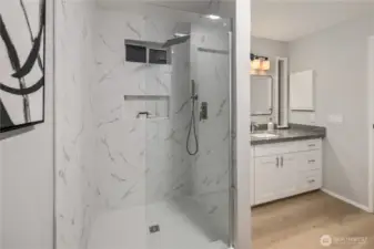 A gentle rain showerhead and convenient cutouts complete the shower