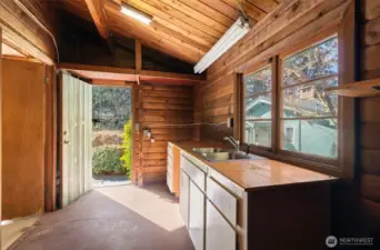 There’s also an adjacent space with a sink, giving you extra room and functionality for projects, hobbies, or just a little extra clean-up before heading inside.