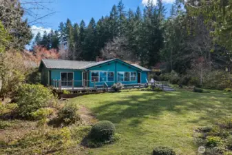 There’s plenty of room for summer gatherings between the house and the waterfront... an inviting stretch of outdoor space that feels made for good conversation, easy laughter, and long afternoons near the water.