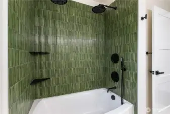 Double shower heads with dual controls and a shower wand.