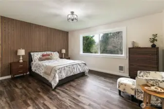 The primary suite is quite large and has a walk-in, as well. Queen sized bed with storage drawers for size reference.