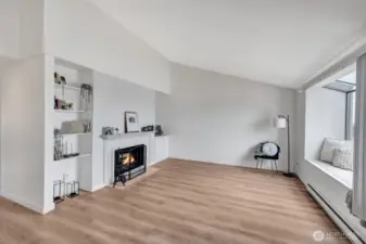 Light and bright living room has vaulted ceiling, fireplace, bay window and nice floors throughout.