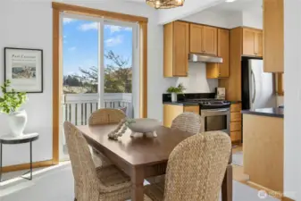 The dining area adjacent to the kitchen. The sliding glass door leads out onto the deck.