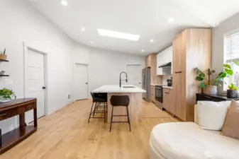 Bright open-concept living with a spacious kitchen and vaulted ceilings.