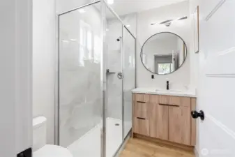 Beautiful primary bathroom featuring a sleek glass walk-in shower modern vanity, and stylish finishes throughout.