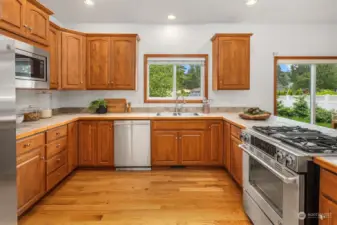 This kitchen has ample space to move around and features lots of cabinet space and stainless steel appliances.