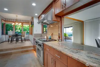 Gorgeous granite slab countertops with complementing custom tile backsplash.