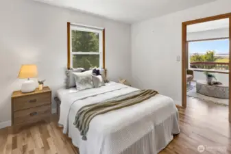 The main level bedroom is spacious and bright