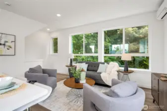 Generous windows with peaceful green screen outlook.