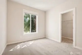 Comfortable main floor bedroom featuring a roomy walk-in closet.