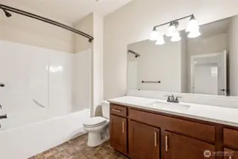 Lower level hall bath with clean, functional design and new quartz counters.
