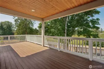 Expansive main floor deck offers open and covered spaces for versatile outdoor living.