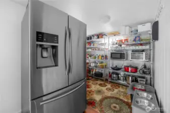 This extra finished room off of the kitchen is amazing for storage.