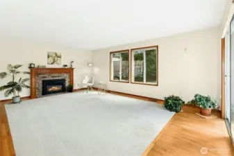 Large family room with Heat-n-Glo gas fireplace and access to entertainment sized deck and yard.