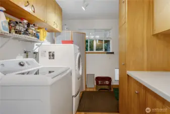 Large laundry room with more storage and leads to the oversized 2 car garage.